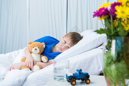 抱着泰迪熊躺在医院床上图片