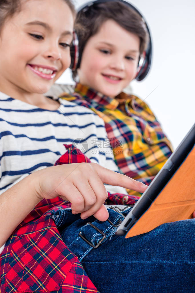 带耳机和数字平板电脑的儿童在图片