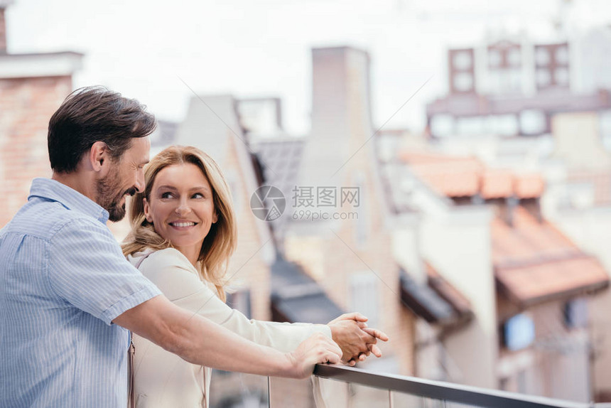 幸福的情侣在阳台上拥图片