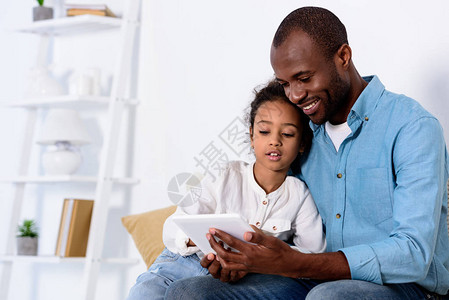 African美国父亲和女儿在家里的平板图片