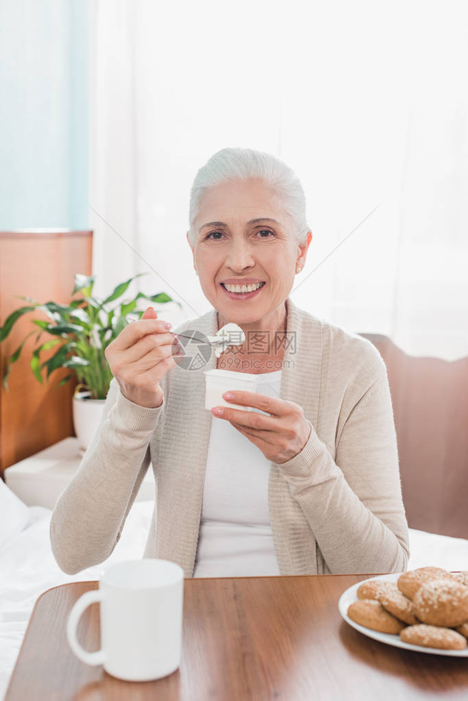 快乐的老女人吃酸奶图片