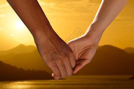 情侣牵手看美丽的日落背景图片