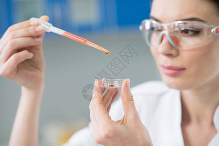 身戴保护眼镜的女科学家在实验图片