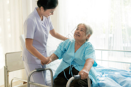 亚洲年轻护士支持老年病人残疾妇女在医院使用助行器老年图片