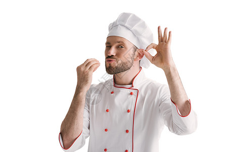 英俊的厨师在白色上显示出好的迹象图片