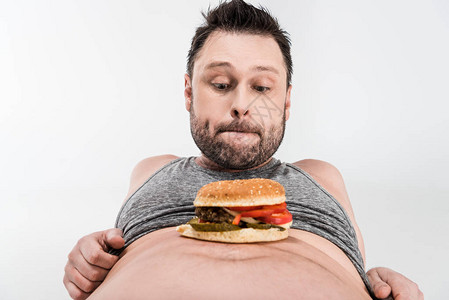 体重超的人看着肚子上的汉堡图片