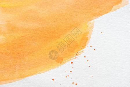 抽象的橙色水彩画与白纸上的油漆污点背景图片