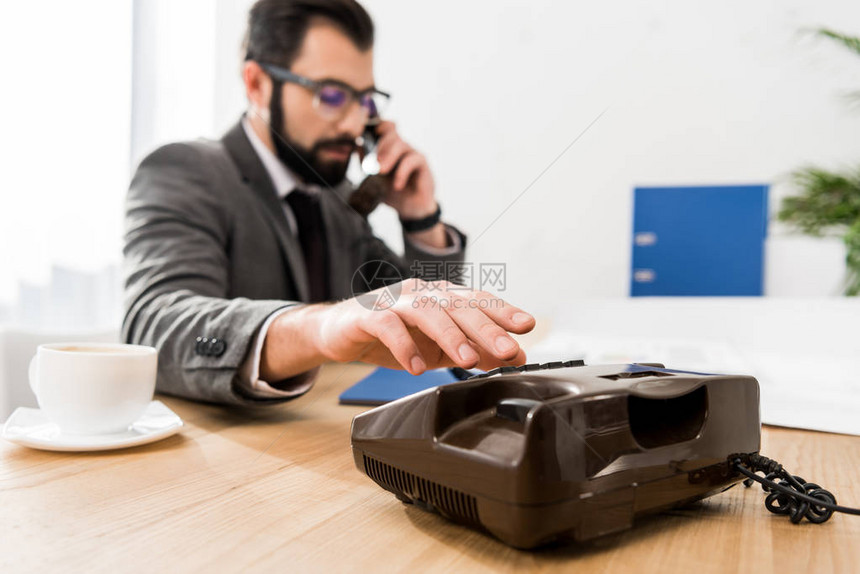 商人在办公室用固定电话拨打号码图片