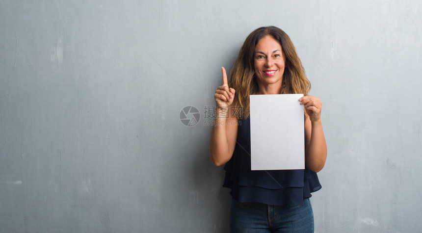 中年的黑皮女人拿着银行纸单惊讶于一个想法或问题与快乐的面孔对图片