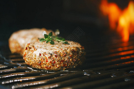 用薄荷和羊肉调味的羊肉汉堡在烧烤架上用火焰摩擦图片