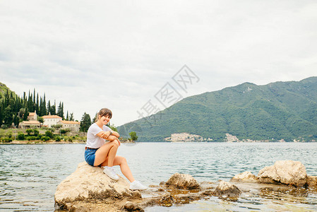 坐在悬崖上看海的女士图片