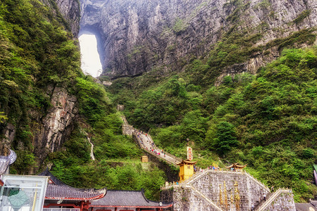 一座大水侵蚀了两座山峰之间的洞穴在Chiangjiajie的锡亚门山图片