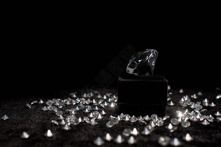 靠近宝石的钻石在黑色的天鹅绒上背景图片