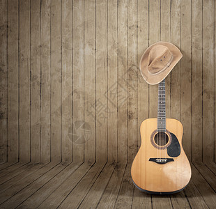 牛仔帽和吉他木制背景图片