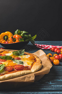 用樱桃番茄和罗勒开胃自制披萨的特写图片