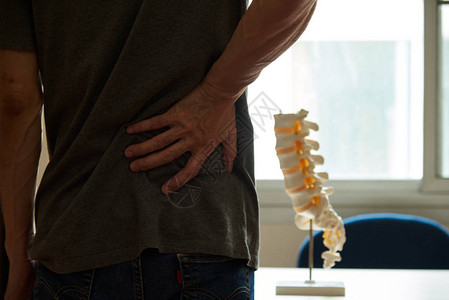 男病人到诊所接受低背痛治疗图片