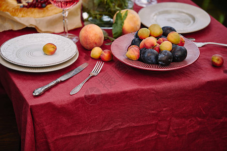 花园桌上的水果盘子和餐具图片