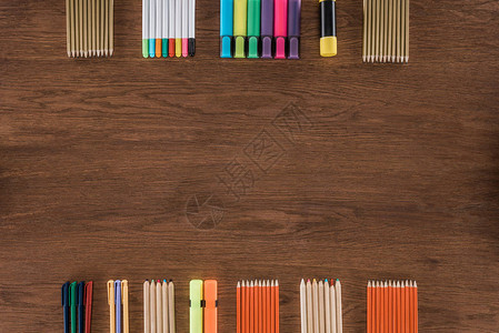 木制表格上排列的彩色铅笔和标图片
