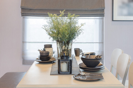 餐厅里的木制餐桌和玻璃花瓶植物图片