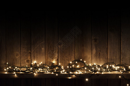 木墙背景上的圣诞灯图片