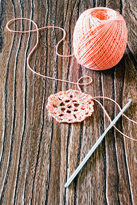 棉纱和钩子木制背景上的针线活配件图片