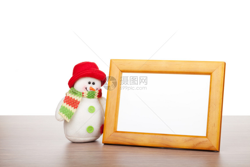 空白照片框和木制桌上的圣诞节雪人白图片