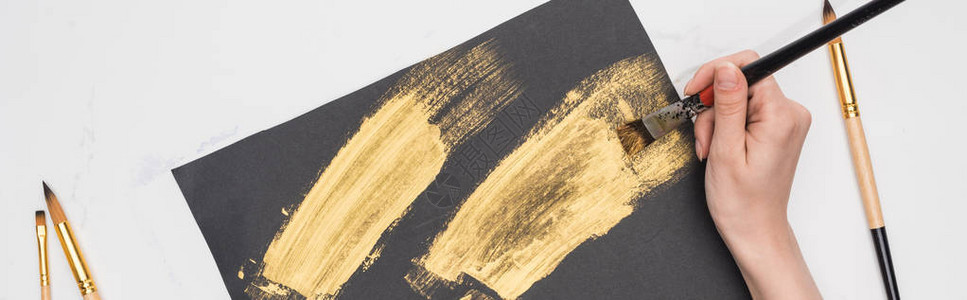 在大理石表面的黑纸上涂有金漆的画作图片