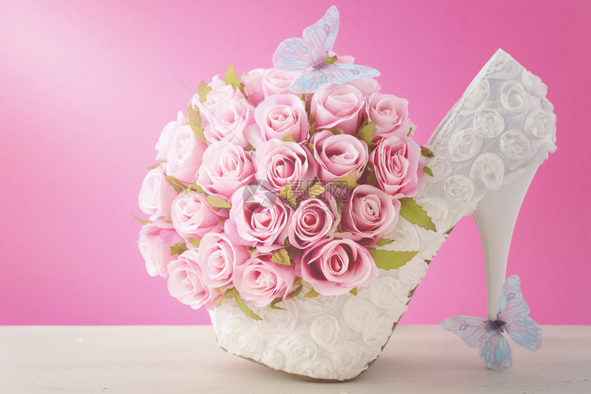 粉红色和白色花束丝玫瑰蓝蝴蝶和白高跟鞋图片