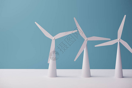 白色桌子和蓝色背景上的风车模型图片