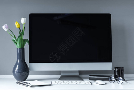 白色工作台上的郁金香花瓶图片