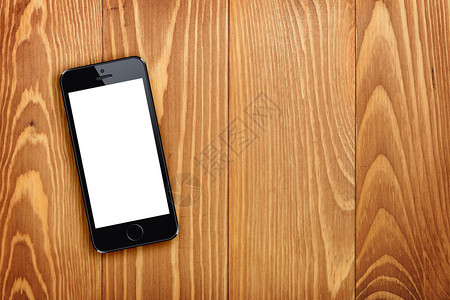 带复制空间的木桌背景智能电话图片