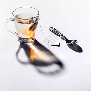 玻璃杯红茶和勺子在桌子上图片