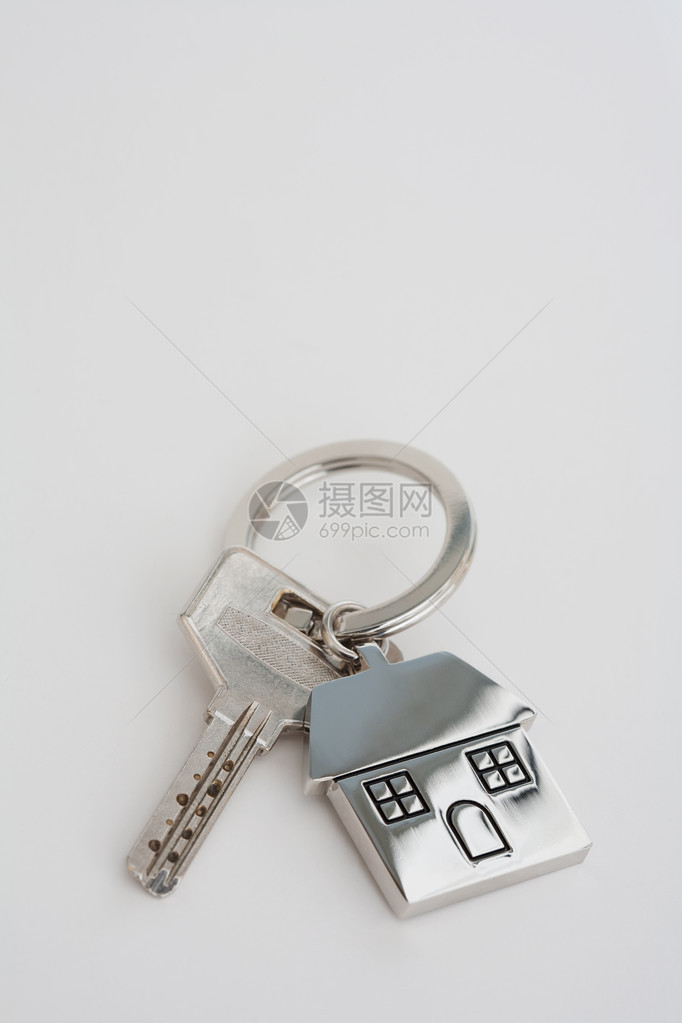 新房主抵押钥匙和钥匙圈放在一张白色的桌子上图片