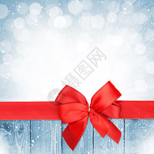 红丝带在圣诞节的雪木背景和复图片