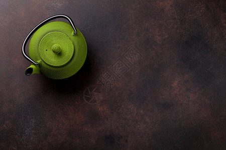 石桌上的绿色茶壶顶视图图片