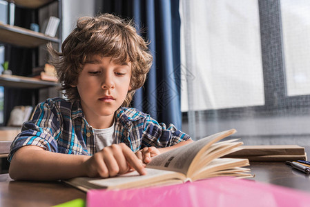 独自做功课时读书的小男孩图片