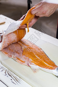 雄手摸鱼肉食用板上切鱼主厨吃鱼做图片