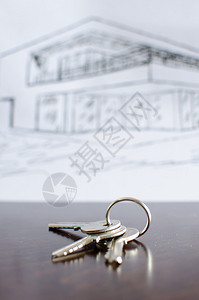 在一张木桌上的房子钥匙背景图片