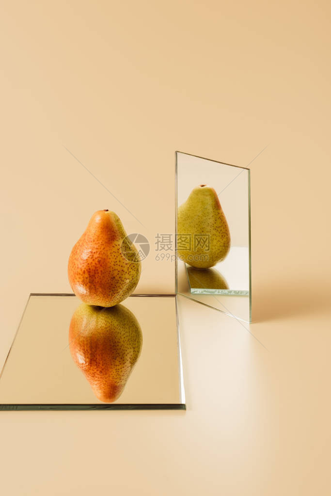 1个成熟的梨子在米色桌上两图片