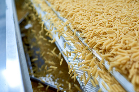 现代食品生产厂机器单元溢出的干通心粉特图片