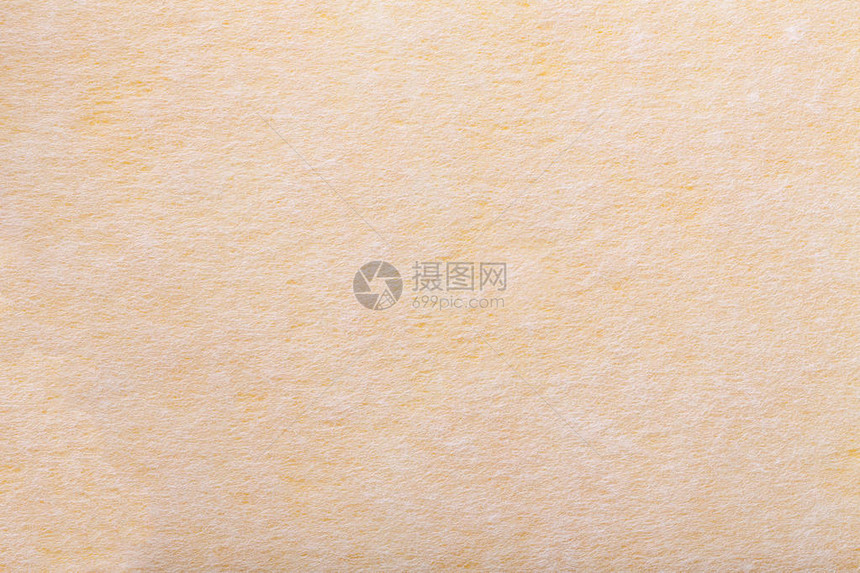 浅黄色背景的构造与毛毡织物的白点图片