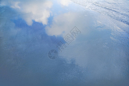 云在海滩波浪中的反射图片