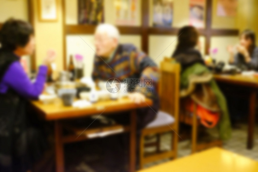 摘要模糊了在日本餐厅聊天喝酒和吃饭的人图片