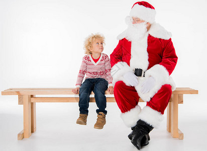圣诞老人和孩子坐在长椅上的孩子图片