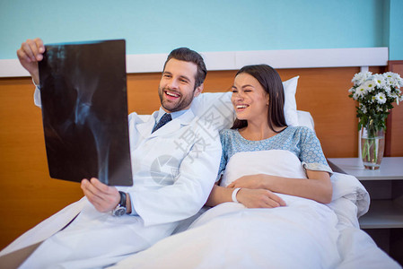 微笑的男医生和女病人在医院看图片