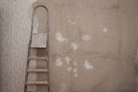旧的混凝土墙纸被撕毁靠墙的梯子图片