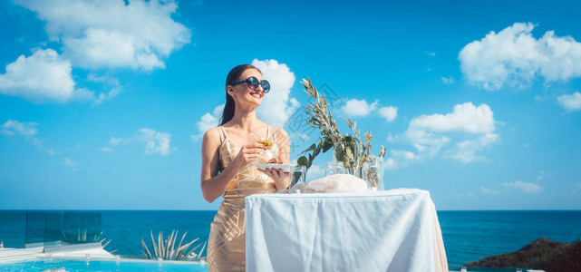 穿着衣服的女人在海滩派对上有食物有泳池图片