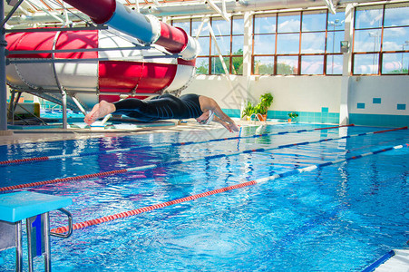 专业运动员从平台跳进水池里的水中从平台图片