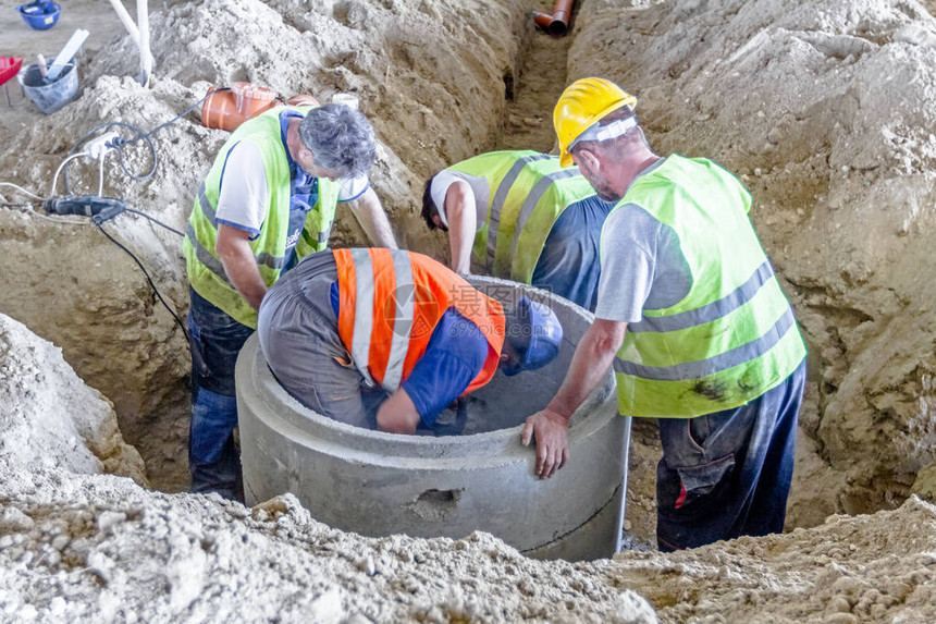 施工人正在建筑工地上装配新的混凝土坑洞图片