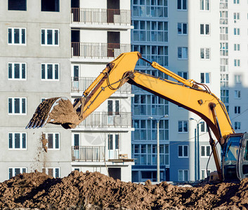 黄挖土机在建筑工地挖掘地面图片